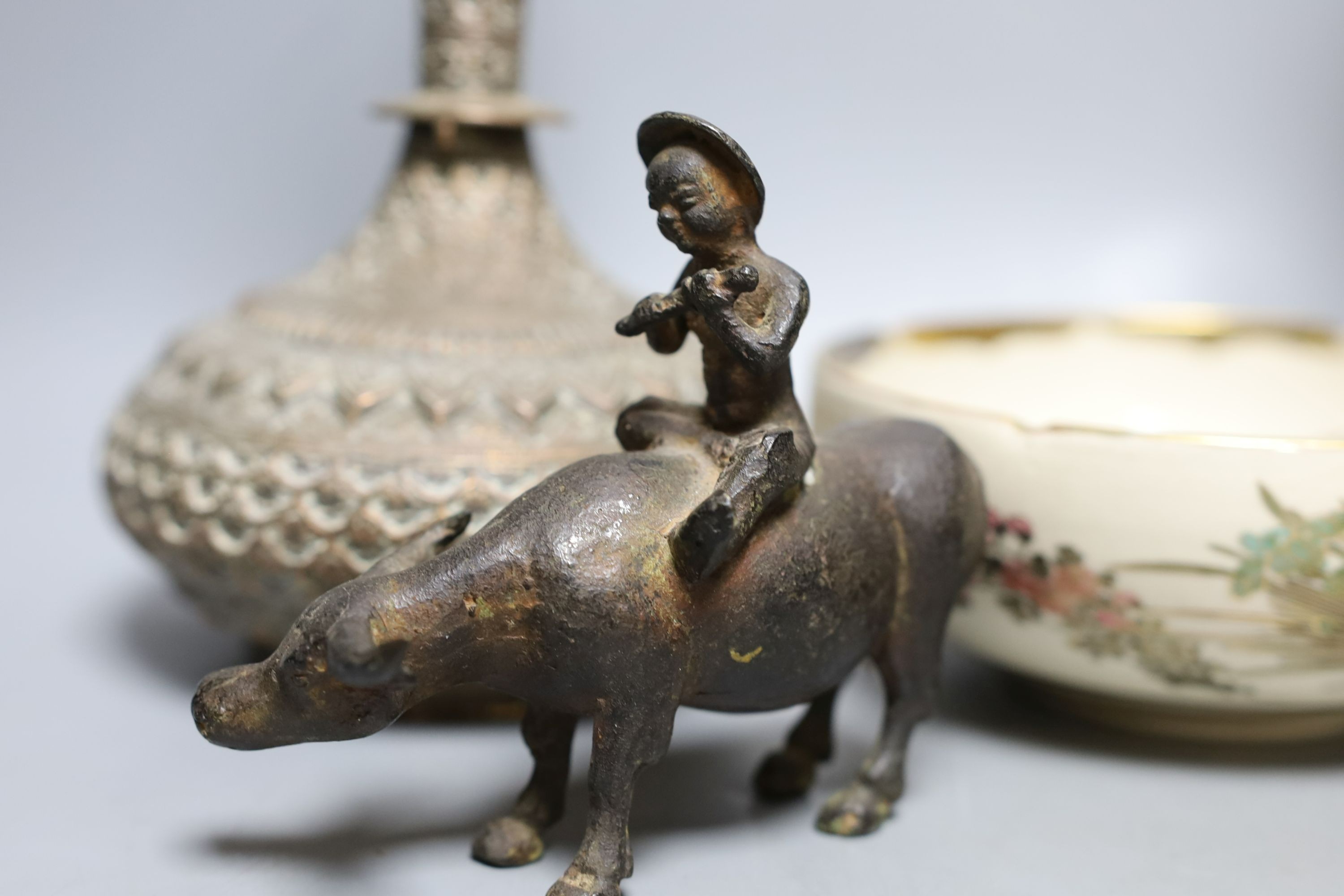 A Japanese bronze vase, an Islamic brass bottle, Chinese enamelled porcelain bowl, bronze group of man riding an ox. 29cm